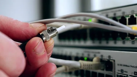 Network engineer inspects fiber cable on computer switch Stock Footage 200649793