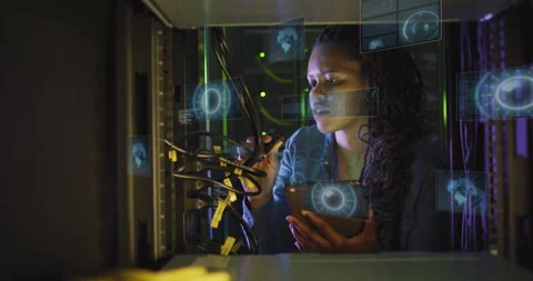Network engineer organizing yellow Ethernet cables in data center rack, showing Stock Footage 309068742