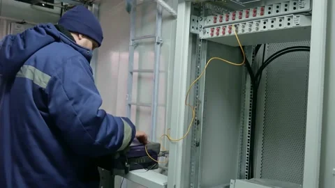 Network engineer in server room with optical patchcord. Stock Footage 151074663