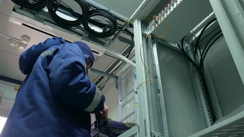 Network engineer in server room with optical patchcord. Stock Footage 151079437