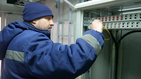Network engineer in server room with optical patchcord. Stock Footage 151079460