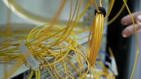 Network engineer in server room works with optical patchcord and optical module. Stock Footage 126950232