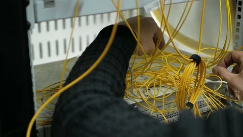 Network engineer in server room works with optical patchcord and optical module. Stock Footage 126956069