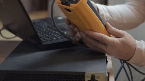 Network engineer testing Ethernet connections with network testing Stock Footage 120397543