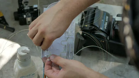 A network engineer works with optical fiber equipment Stock Footage 112184156