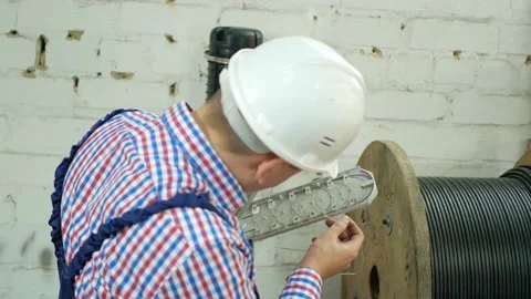 A network engineer works with optical fiber equipment Stock Footage 150636090