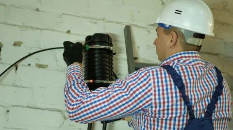 A network engineer works with optical fiber equipment Stock Photos