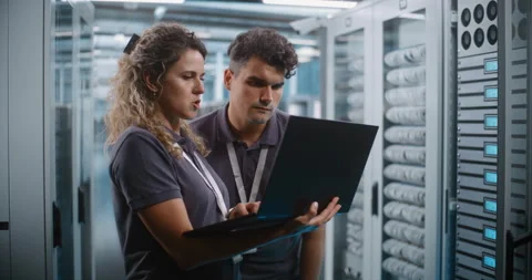 Network Engineers Analyzing System Telemetry Together in Data Center Stock Footage 344883713