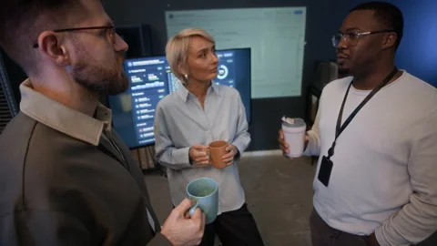 Network Engineers Communicating during Coffee Break in Modern Office Stock Footage 334936302