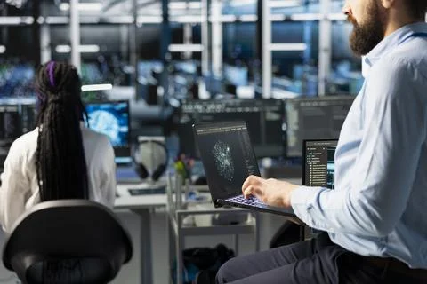 Network engineers in data center troubleshooting connectivity issues using AI Stock Photos