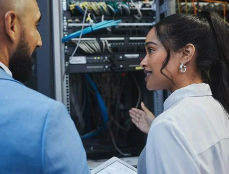 Network engineers, discussion and server room for internet infrastructure and Stock Photos