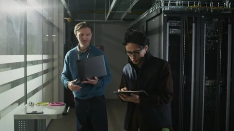 Network Engineers Entering Server Rack in Data Center Stock Footage 330547258