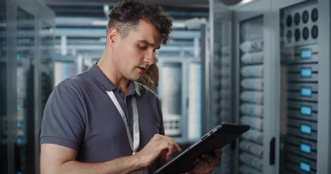 Network Engineers Managing Data Center Hardware with Mobile Tablet Vídeo Stock 344888414