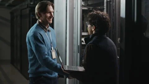 Network Engineers Shaking Hands after Successful Server Setup in Data Center Stock Footage 330547424