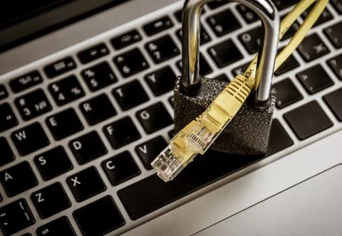 Network ethernet cables in padlock on computer keyboard Stock Photos