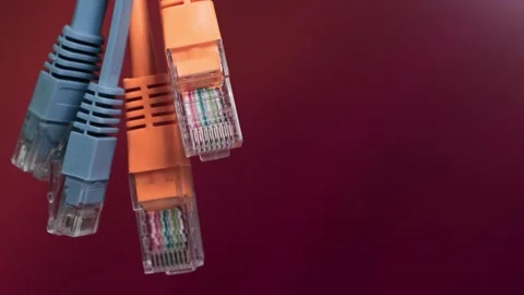 Network ethernet cables with rj45 connectors on maroon background Stock Footage 337789371