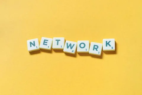 Network formed of scrabble elements on yellow background. Stock Photos