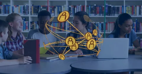 Network graphic expanding above library table students flipping pages noting for Video stock 316190712