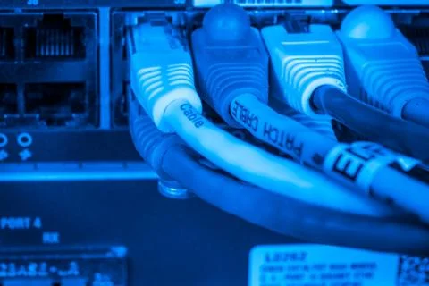 Network hub and patch cables Stock Photos