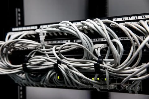 Network panel, switch and cables in data center. Stock Photos