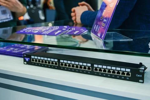 Network patch panel on exhibition counter. Professional equipment for data .. Stock Photos