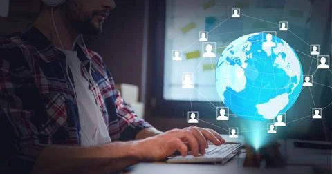 Network of profile icons over globe against mid section of man using computer at 写真素材