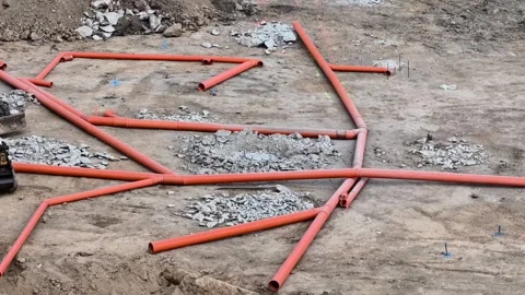 The network of red pipes at the busy construction site boosts overall efficiency Stock Footage 314031753