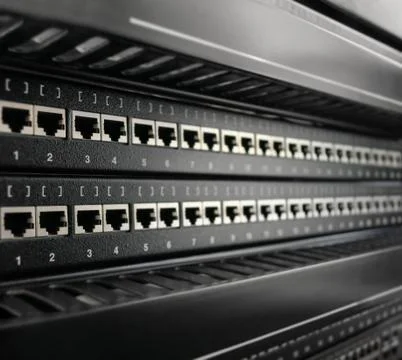 Network RJ-45 patch panel in switching center. Close up view with selective f Stock Photos