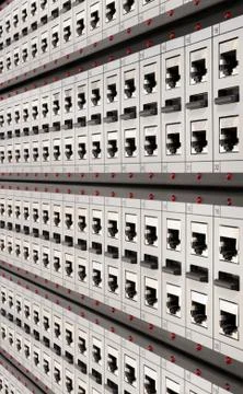 Network RJ-45 patch panel with switches in the switching center. Close up vie Stock Photos