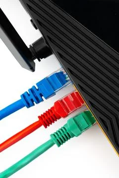 Network router with colored Ethernet cables connected for internet access and Stock Photos