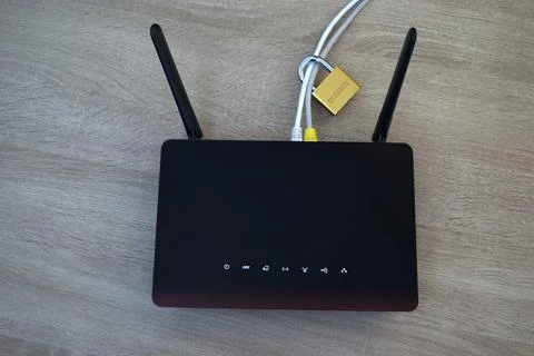 Network security concept with padlock on cables connected to router Stock Photos