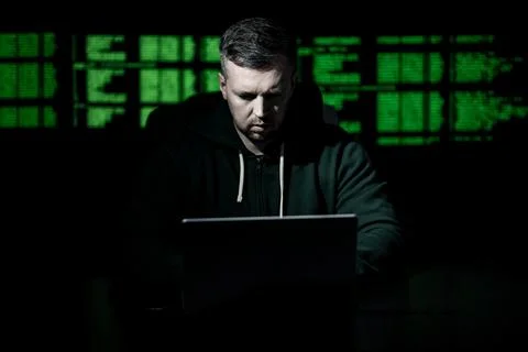 Network security specialist uses laptop. Network security specialist monitors Stock Photos