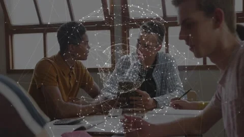 Network sphere appearing above table, students examining smartphone data and 動画素材 326307273