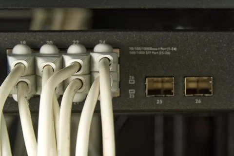 Network switch and ethernet cable in rack cabinet. Network connection technology Stock Photos