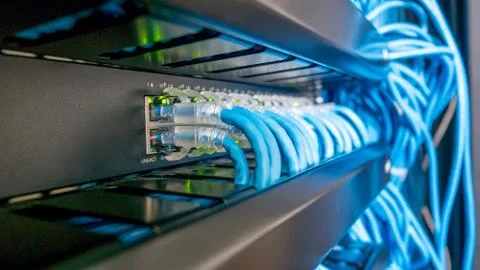 Network switch and ethernet cables connected Stock Photos