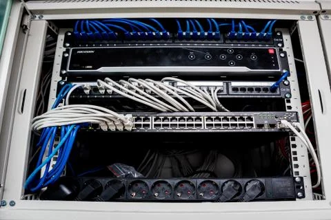 Network switch and ethernet cables in red and white colors. Data Center Stock Photos