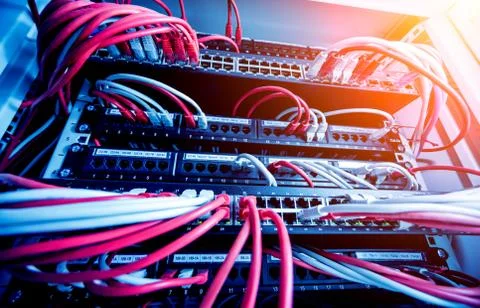 Network switch and ethernet cables in red and white colors. Data Center Stock Photos