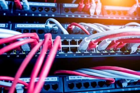 Network switch and ethernet cables in red and white colors. Data Center Stock Photos