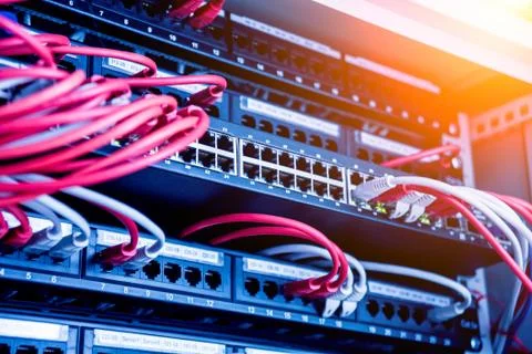 Network switch and ethernet cables in red and white colors. Data Center Stock Photos