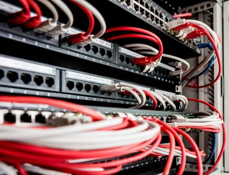 Network switch and ethernet cables in red and white colors. Data Center Foto stock