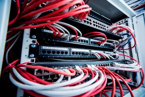 Network switch and ethernet cables in red and white colors. Data Center Stock Photos