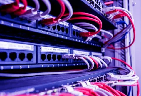 Network switch and ethernet cables in red and white colors. Data Center Stock Photos