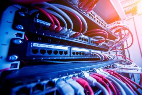 Network switch and ethernet cables in red and white colors. Data Center Stock Photos