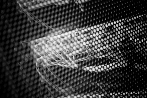 Network switch behind mesh Stock Photos