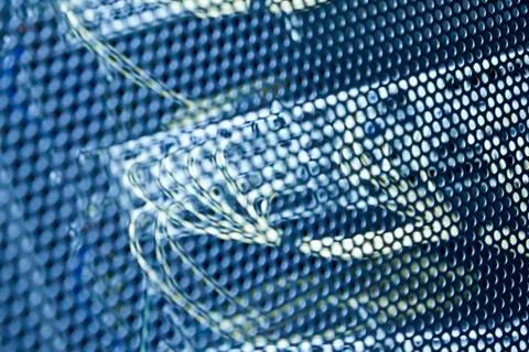 Network switch behind mesh Stock Photos