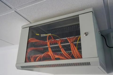 Network switch enclosure high up on a ceiling in a office Foto stock