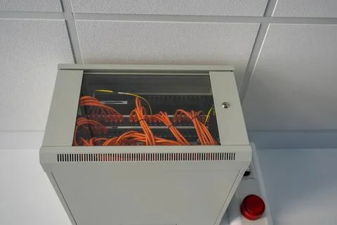 Network switch enclosure high up on a ceiling in a office Stock Photos