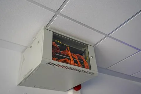 Network switch enclosure high up on a ceiling in a office Foto stock