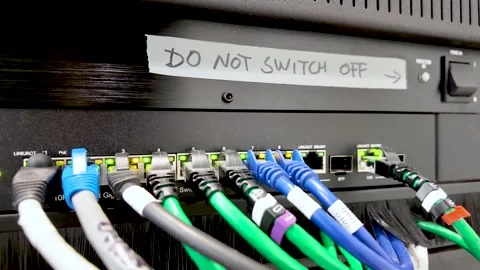 Network Switch With Ethernet Cables Connected To Ports And A Warning Sign Stock Footage 328143176