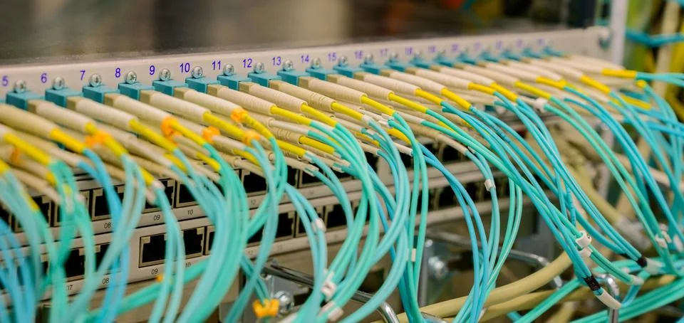 Network switch with fiber optic network cables in a data center Stock Photos